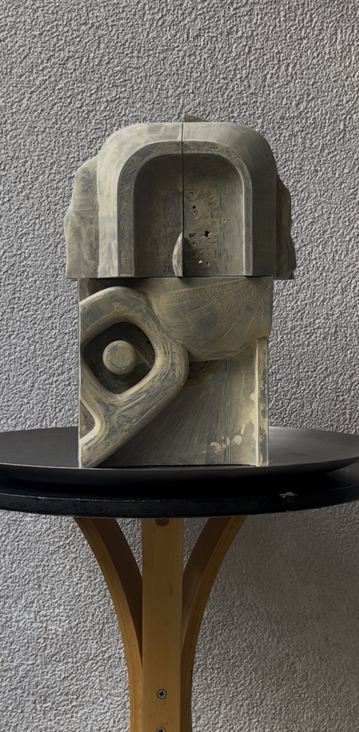 Detail view of Study I, showing the upper arched block and the hooked, eye-like carved element