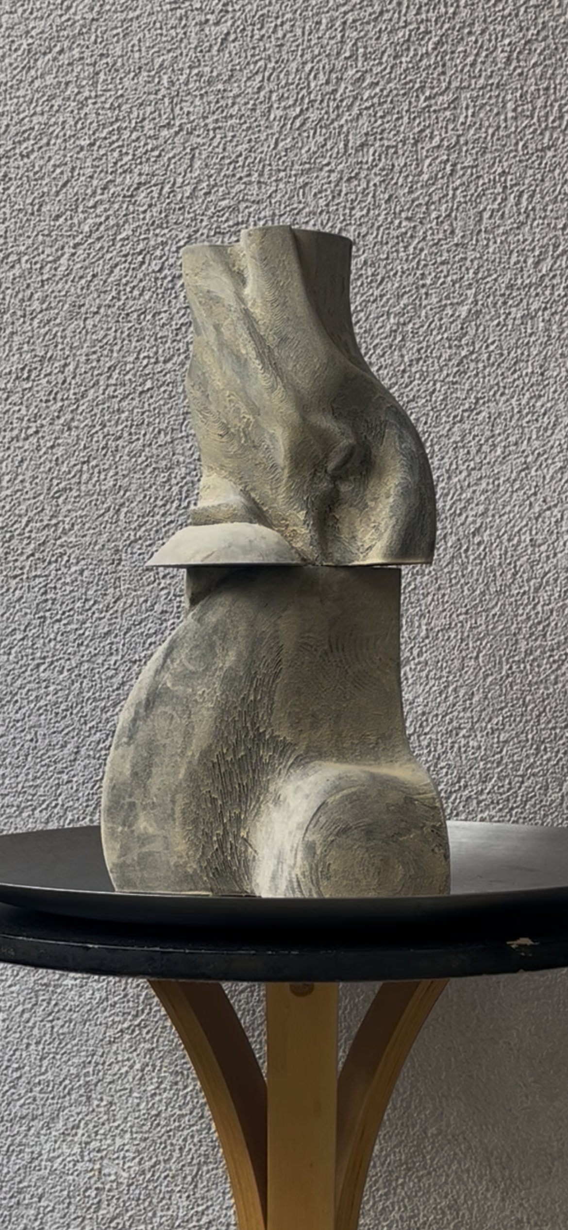 Study III: a two-part carved sculptural form, a deeply draped and folded upper block resting on a rounded, swirl-textured base, in grey and bone tones.