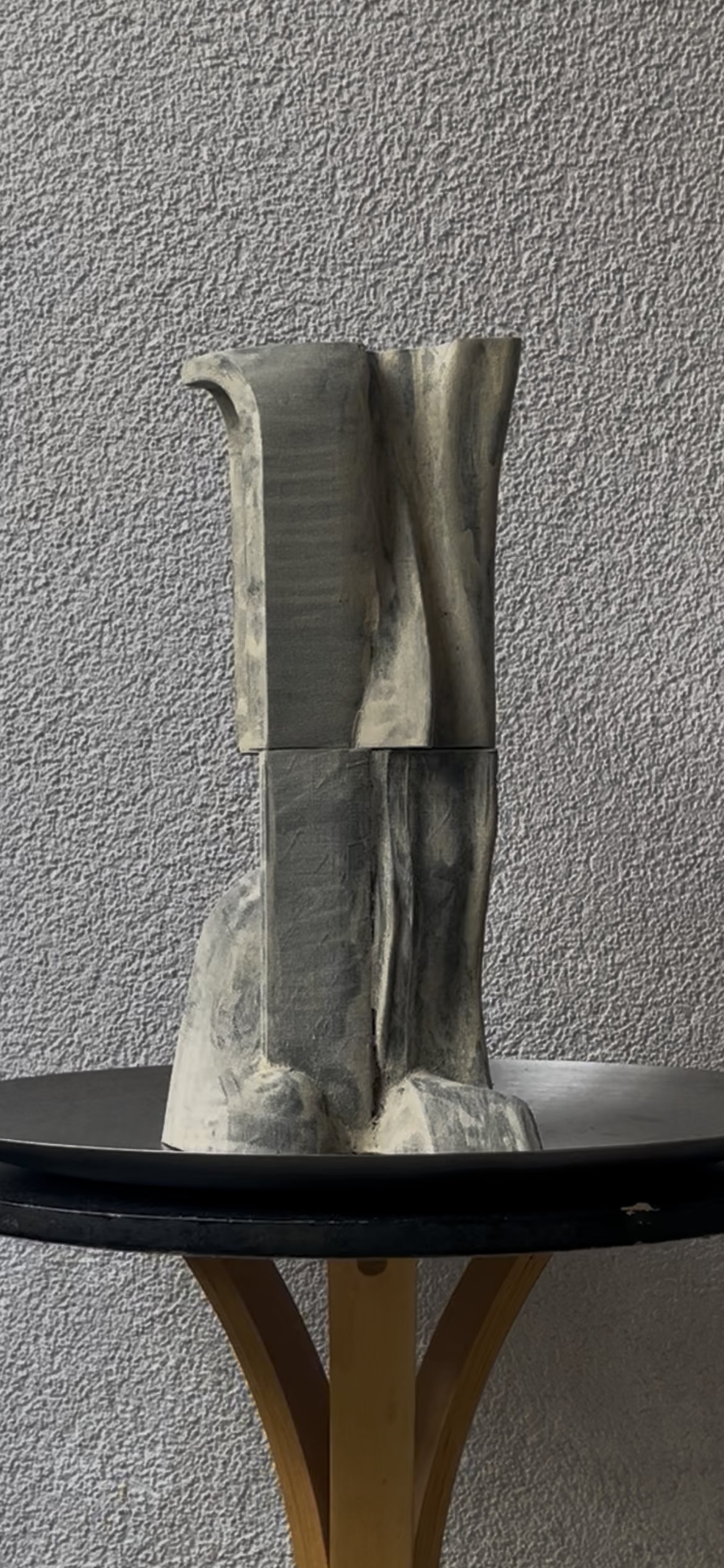 Study IV: a paneled, vertically grooved carved sculptural totem with a curled lip detail at the top edge, in grey and bone tones.